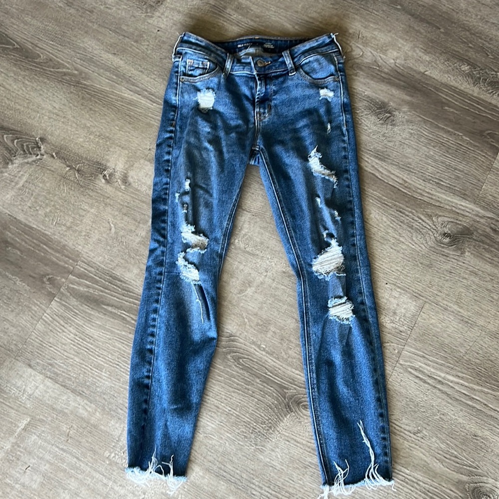 Old Navy mid-rise rockstar super skinny jeans with intentional rips all over.